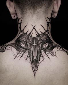 the back of a man's neck with an animal skull and horns on it