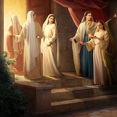 three women dressed in white robes standing on steps