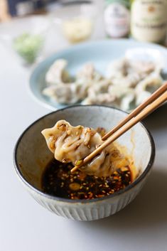 chopsticks sticking out of a bowl filled with food