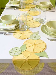 the table is set with yellow and green place mats