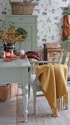 a dining room table and chairs with blankets on them