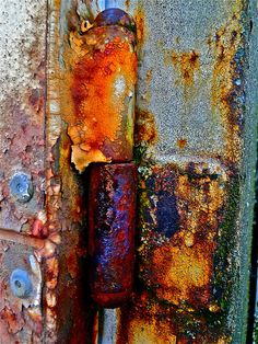 an old rusted metal door handle with rivets