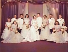 a group of people in formal wear posing for a photo