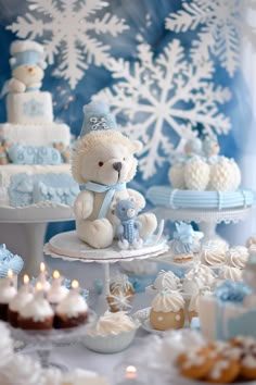 a white teddy bear sitting on top of a table next to cakes and cupcakes