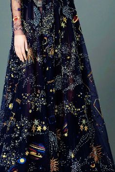 a woman in a dress with stars and planets on it