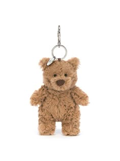 a brown teddy bear keychain hanging from a metal hook on a white background