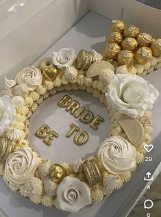 a cake decorated with flowers and chocolates in the shape of a number on it