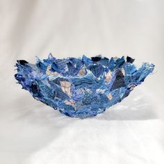 a blue bowl sitting on top of a white table