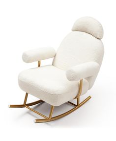 a white rocking chair with gold legs and a seat cushion on the back, in front of a white background