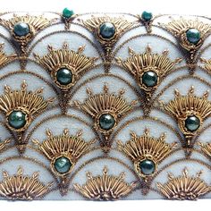 an intricately designed clutch bag with green beads