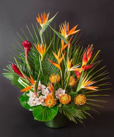 an arrangement of tropical flowers and greenery