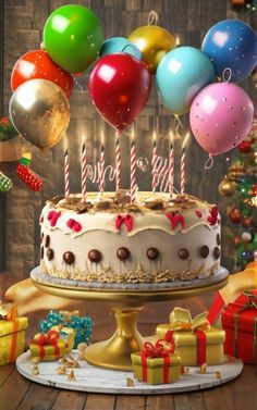 a birthday cake with balloons and presents on the table