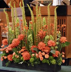 an arrangement of flowers in a wooden box