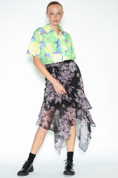 This midi-length skirt features graceful ruffle drape layers in silk, Crafted from light and breathable fabric. The charming black and lavender floral prints create a beautiful blend suitable for both vacations and work settings. The skirt is lined with black fabric, with an invisible zipper on the back for ease of wear. Composition: 100% Silk Mid-weight fabric Designed for a regular fit, Fits true to size Skirt length of size M is 27.5 inches Made in New York Lavender Floral, American Fashion Designers, Midi Length Skirts, Layered Skirt, Lavender Color, Zambia, Office Wear, Black Fabric, Uganda