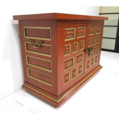 a wooden cabinet sitting on top of a white floor