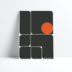 a black and orange poster on a white wall with an orange dot in the center