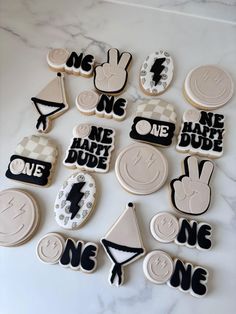 decorated cookies are arranged in the shape of letters and numbers on a marble countertop