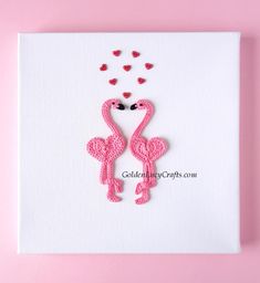 two pink flamingos in the shape of hearts on a white canvas with red thread