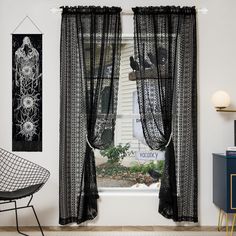 a black and white room with two chairs, one chair is next to the window