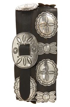 Made in collaboration with renowned Navajo silversmith Jimmy Begay, this hand-finished belt is meticulously rendered using traditional wax casting techniques. The design—reminiscent of Navajo Third Phase concho belts—features cast silver-plated brass pieces with repoussé and traditional stamped motifs, alternating between butterflies and oval conchos, and a single-prong oval-shaped buckle on a vegetable-tanned leather strap. Leather Made in the USA Black Western Belt, Concho Belts, Belt Buckles Men's, Cowboy Belt Buckles, Cowboy Belt, Western Buckles, Western Accessories, Concho Belt, Purple Label