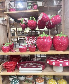 the shelves are filled with many different types of plates and bowls, including strawberries