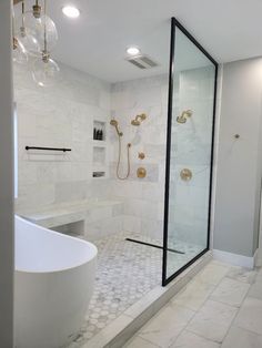 a bathroom with a tub, shower and chandelier