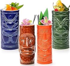 four different colored vases with designs on them