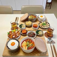 a table topped with lots of different types of food and bowls on top of it