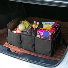 an open trunk filled with groceries and fruit in the back of a white car on a sunny day