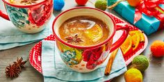 two mugs filled with hot chocolate on top of a table