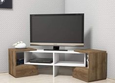 an entertainment center with a flat screen tv mounted on it's side, in a living room