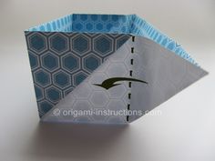 an origami box with blue and white designs