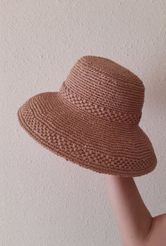 Women's hat crocheted from viscose raffia in beige color. Raffia is a natural, environmentally friendly, biodegradable and hygroscopic material. The hat is stylish, comfortable, transpirable, light and very durable, it will last more than one year. Perfect for the summer. The last row is specially reinforced and keeps its shape perfectly. Dimensions: Head circumference 57-58 cm Hat brim 10 cm Care: Do not wash. Wipe it with a clean damp cloth. In case it is wrinkled or out of shape, you can steam it with an iron at medium temperature. Can be sent to you immediately after ordering. If you have any questions regarding this hat, feel free to ask. You can also find me on Instagram @liana.knitting.craft Gardening Hat, Raffia Hat, Beige Color, Sun Hats, Floppy Hat, Hats For Women, Biodegradable Products, Caps Hats, Accessories Hats