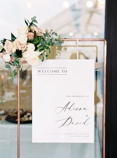 a welcome sign with flowers on it