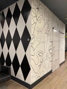 an office with black and white wallpaper on the walls