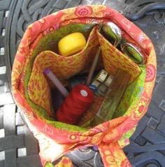 a bag with various items inside sitting on the ground