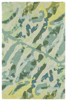 a green and blue area rug with abstract designs on the bottom, in various shades