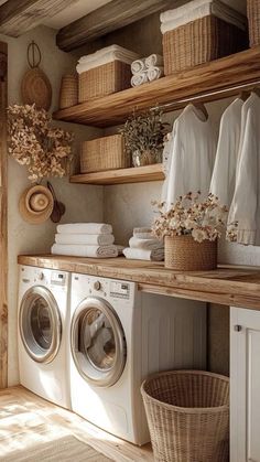 a washer and dryer in a room with wooden shelves on the wall next to each other