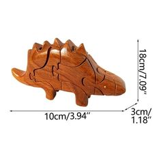 the wooden toy is shaped like an alligator's head and has been made from wood