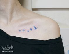 a woman's chest with blue birds on it