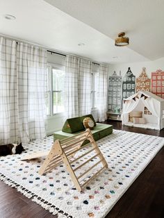 a living room with a green couch and white rug on top of it, in front of a window