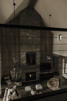 a living room filled with furniture and a fire place in the middle of a room