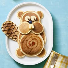 a white plate topped with pancakes and a teddy bear