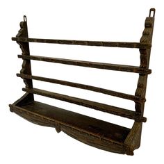 an old wooden shelf with three shelves on it's sides and two hanging hooks