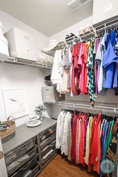 an organized closet with clothes hanging on the shelves and drawers, along with other items