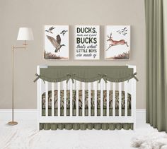 a baby crib with two pictures on the wall