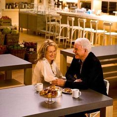 two people sitting at a table in a restaurant