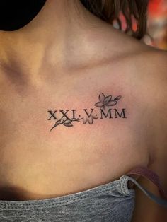 25 Gorgeous Roman Numeral Tattoo Designs - Tattoo Pro Tattoos On Womens Chest, Hidden Name Tattoo Ideas For Women, Butterfly Roman Numeral Tattoo, Chest Tattoo Female Meaningful, Significant Other Tattoos Names, Medium Tattoos For Women With Meaning, Top Chest Tattoo Female, Tattoo Ideas Female Medium Size, Collarbone Tattoo Female