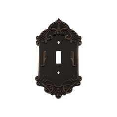 an ornate light switch plate cover in dark bronze with intricate designs on the front and sides