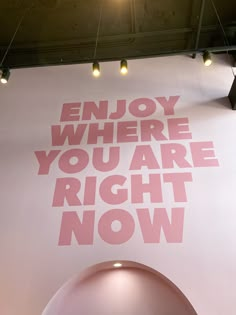 a large sign that says enjoy where you are right now